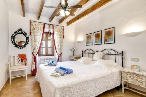 a bedroom with a bed and a ceiling fan at Casa Maria Angela in Artá