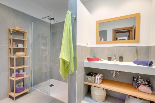 a bathroom with a shower and a sink and a mirror at Villa Kodotoma in Yaiza