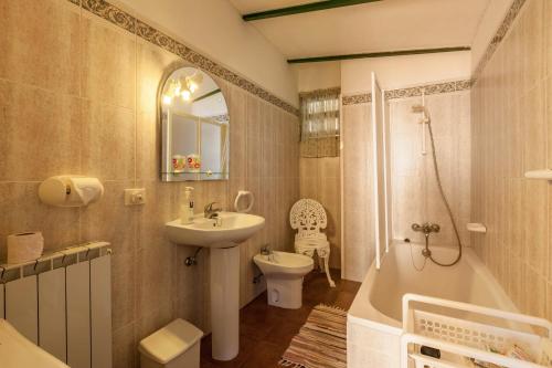 a bathroom with a sink and a tub and a toilet at Casa Victor - Apartment 4 in La Orotava