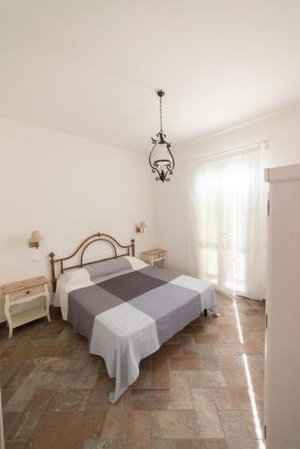 a bedroom with a bed and a chandelier at Il Cisto in Marciana