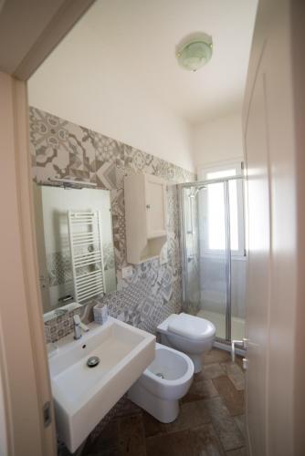 a bathroom with a sink and a toilet and a shower at Il Cisto in Marciana