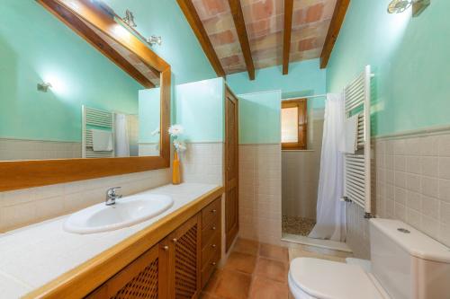 a bathroom with a sink and a toilet and a mirror at Taconera in Artá