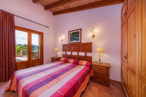 a bedroom with a bed and a window at Taconera in Artá