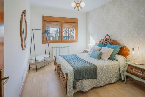 a bedroom with a large bed with blue pillows at El Corcal in Triollo