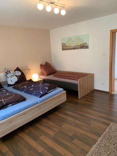a bedroom with two beds and a couch at Ferienwohnung Ödbach mit Terrasse in Konzell