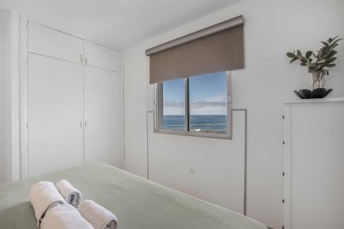 a bedroom with a bed and a window at Vv Tamara Sunset Suite in Tacoronte