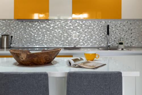 a kitchen with a table with a bowl and a cup at vv Infinity Casilla in La Oliva