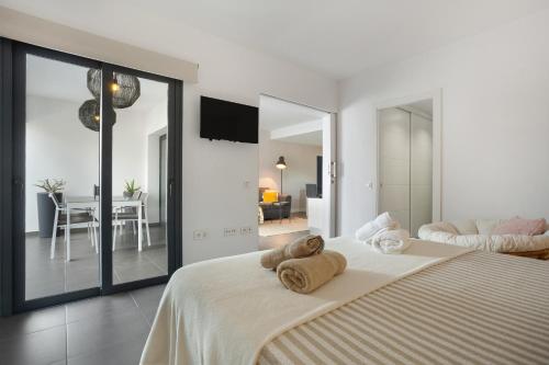 a bedroom with a large bed with towels on it at vv Infinity Casilla in La Oliva