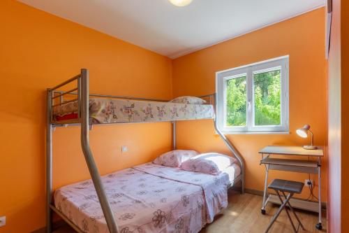 a bedroom with two bunk beds and a desk at Appartement N°3 - Piscine Partagée in Lagorce