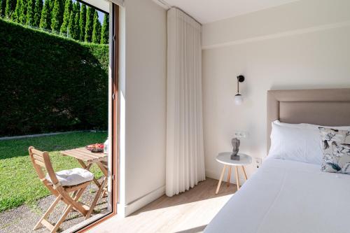 a bedroom with a bed and a sliding glass door at Quinta do Outeirinho - Villa Deluxe in Celorico de Basto