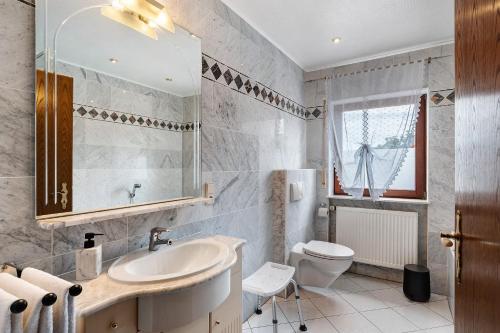 a bathroom with a sink and a toilet at Ferienwohnung Serr in Lauf