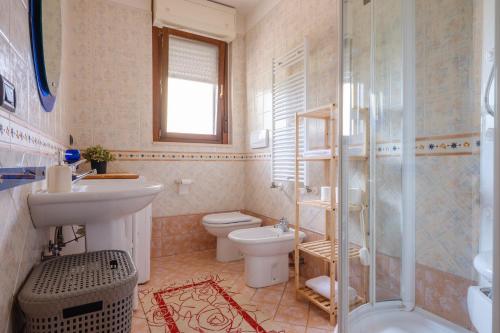 a bathroom with a sink and a toilet and a shower at Appartamento Leo in Brindisi