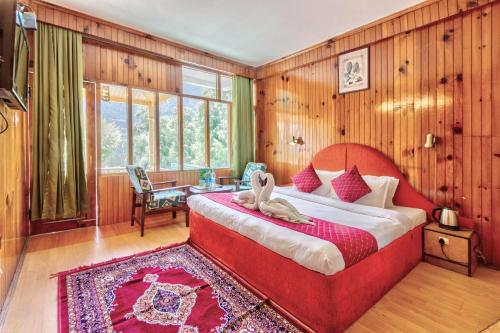 a bedroom with a bed with a stuffed animal on it at MHA hotel ever green manali in Manāli