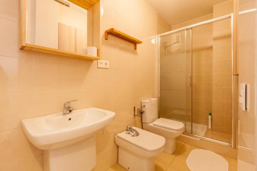 a bathroom with a sink and a toilet and a shower at Freedom Penthouse in Seville