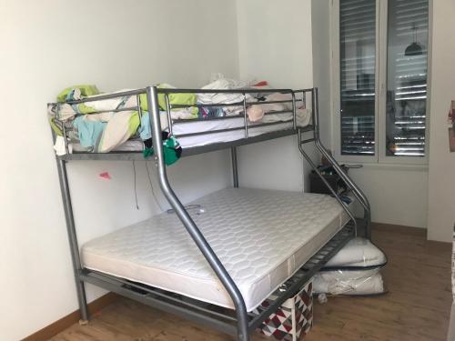 a metal bunk bed in a room at Vacance 16 Pers in La Bourboule