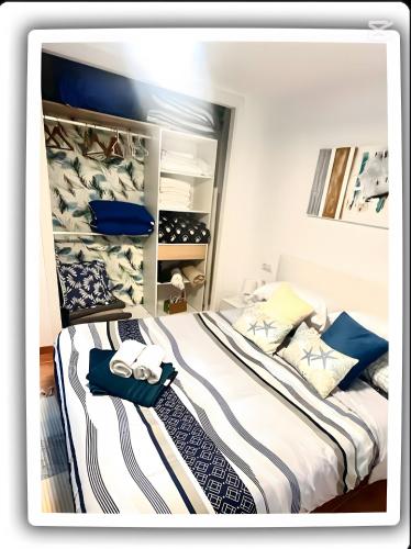 a bedroom with two beds with towels on them at Perlazul in Peniscola