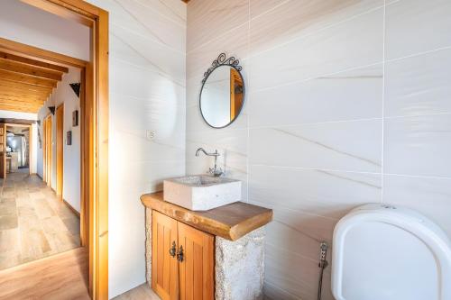 a bathroom with a sink and a mirror at Casa De Basto in Gémeos