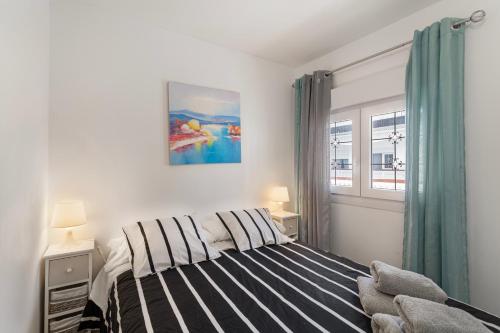 a bedroom with a bed and a window at Casa Paula - 21 in Arinaga