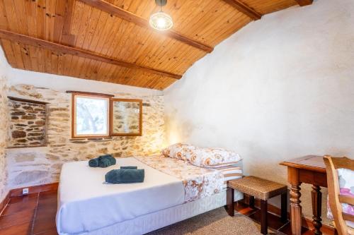a bedroom with a bed and a wooden ceiling at La Fenière - Maison avec terrasse in Collobrières