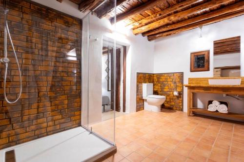 a bathroom with a glass shower stall and a toilet at Can Pep Den Sitges in Sant Joan de Labritja