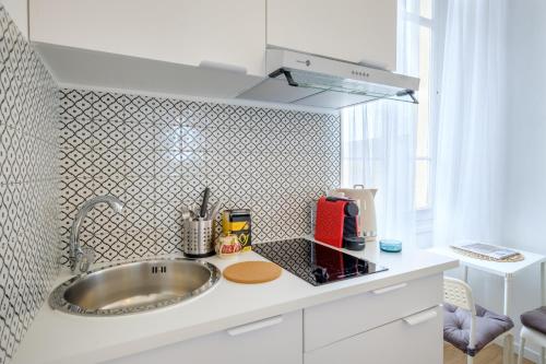 a kitchen with a sink and a counter top at Joli studio près de Monaco in Beausoleil