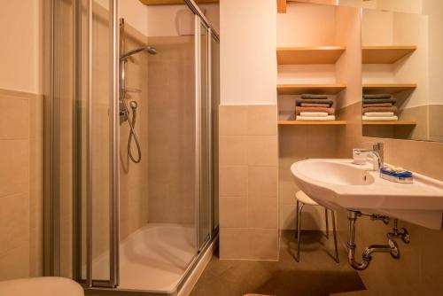 a bathroom with a shower and a sink at Kreuzhof links in Novacella