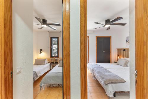 a bedroom with two beds and a mirror at Arizona's Bay in Puerto Rico de Gran Canaria