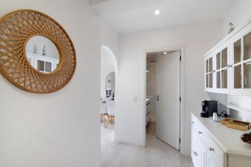 a white kitchen with a mirror on the wall at Luxury Beach View - Praia da Rocha in Portimão
