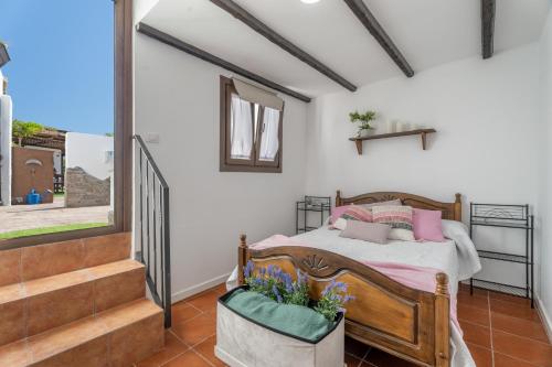a bedroom with a bed and a staircase at Casa Abuelo Manuel in El Draguito