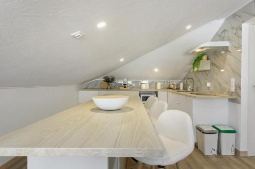 a kitchen with a wooden table and white chairs at Sky and Sea Haven in Santa Cruz