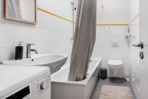 a white bathroom with a sink and a toilet at Hansa Nest in Hamburg