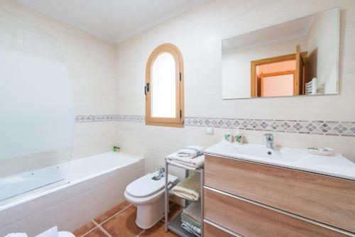 a bathroom with a sink and a toilet and a tub at Ses Llegitimes in Marratxí 