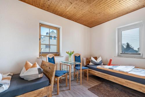 a room with two beds and a table and chairs at Ferienhaus Tanneberg in Tanneberg