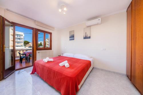 a bedroom with a bed with a red blanket at Cas Bunyoler in Cala Ratjada