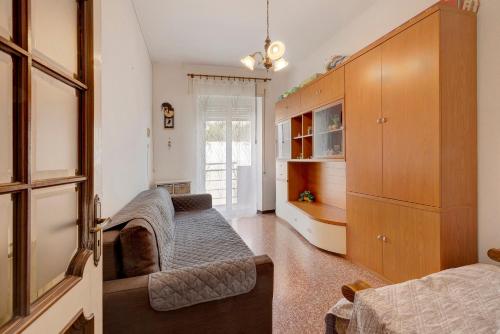 a living room with a couch and a bedroom at A due passi dal mare in Pietra Ligure