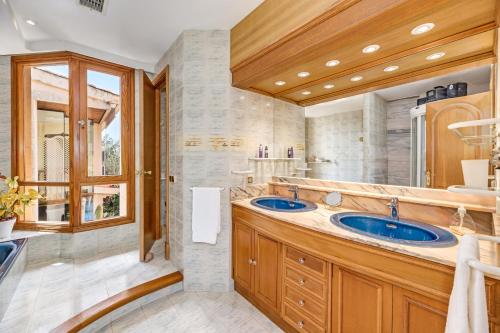 a bathroom with two sinks and a window at Villa Tramontana in Lloseta