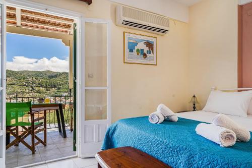 a bedroom with a bed and a balcony at Veroni's studio 1 in Vathi
