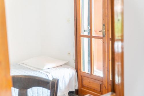 a room with a bed next to a door at Arianna Studio Ground Floor 8 in Paleokastritsa