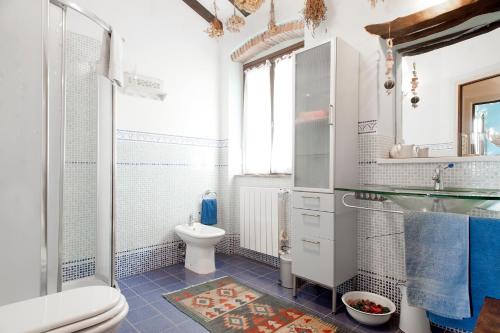 a white bathroom with a toilet and a shower at Mare Colline Città d'Arte in Rosignano Marittimo