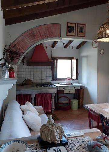 a kitchen with a couch in the middle of a room at Mare Colline Città d'Arte in Rosignano Marittimo