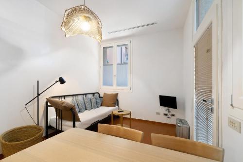 a living room with a couch and a table at U Canetta 2 in Pietra Ligure
