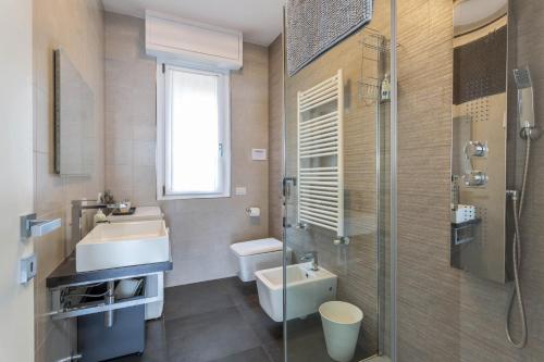 a bathroom with a sink and a toilet and a shower at New Eleven Apartment on Como Lake in Oliveto Lario