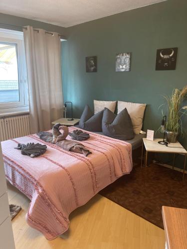 a bedroom with a bed with a pink blanket at Domus Lux 404 in Bad Säckingen