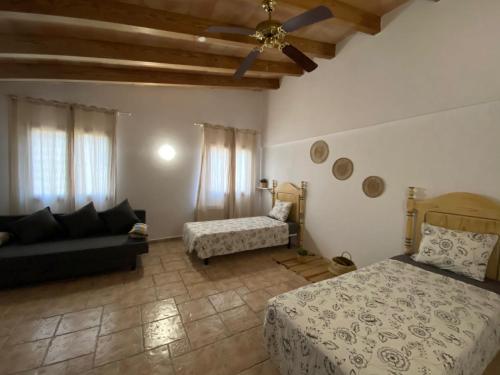 a bedroom with a bed and a couch in a room at The Paradise in Esporles