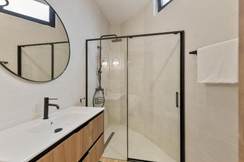 a bathroom with a shower and a sink and a mirror at Finca Los Tilos Moya in Moya