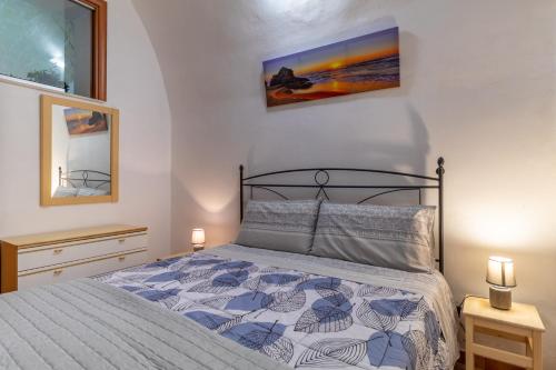 a bedroom with a bed and two night stands at Casa Carmela 53 in Ragusa