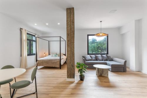 a living room with a couch and a table at Finca Los Tilos Moya in Moya