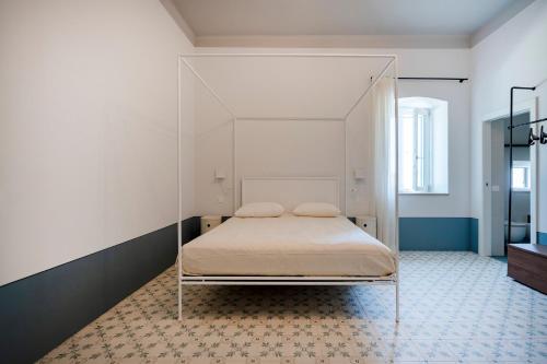 a bedroom with a bed with a canopy at Villa Capobianco in Polignano a Mare