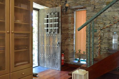 a glass door in a room with a staircase at Quinta Pé Franco in Medrões