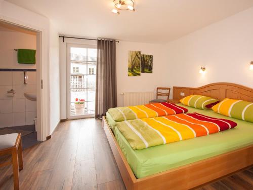 a bedroom with two beds and a bathroom at Ferienhof Bieke in Finnentrop